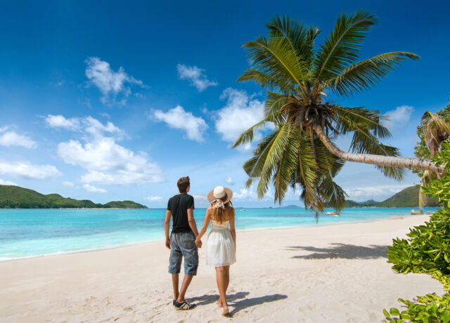 beautiful,young,couple,relaxing,on,an,exotic,beach,from,seychelles.